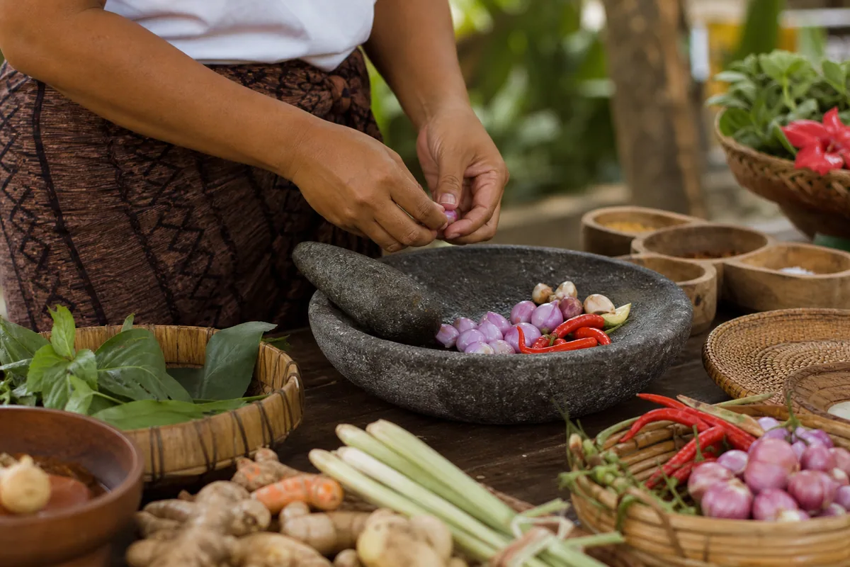 Preparing traditional Balinese ingredients by hand
