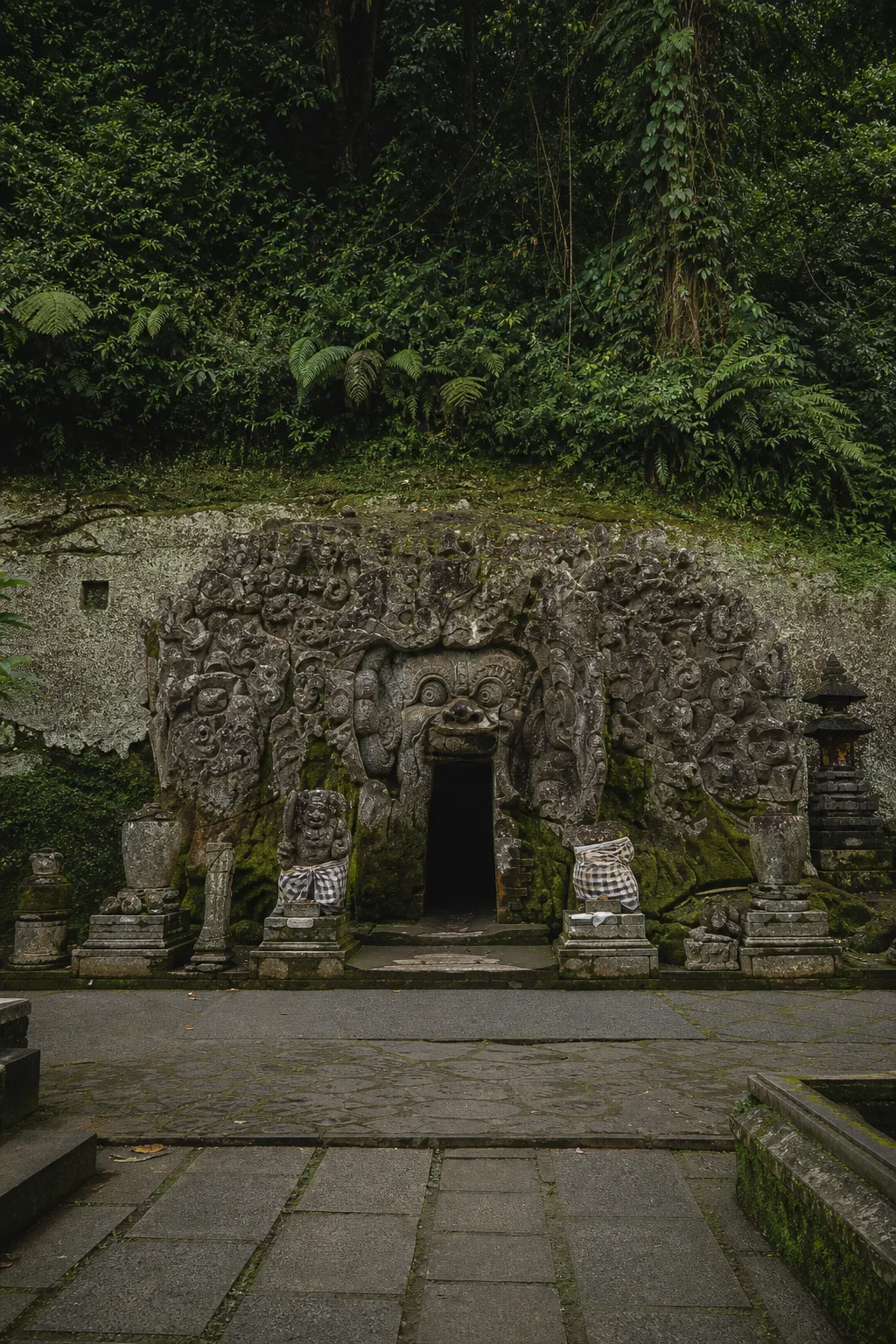 Ancient Goa Gajah cave entrance surrounded by jungle